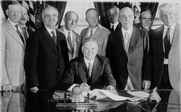 ‘Will the Dairy Cow Save Humanity?’ President Herbert Hoover signing the Farm Relief Bill in 1929.