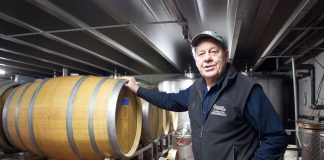Tony Debevc, owner of Debonné Vineyards, in Madison, Ohio, stands in front of barrels of wine in the basement of the winery, Jan. 22.