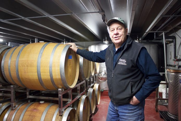 debonne_2 Tony Debevc, owner of Debonné Vineyards, in Madison, Ohio, stands in front of barrels of wine in the basement of the winery, Jan. 22.