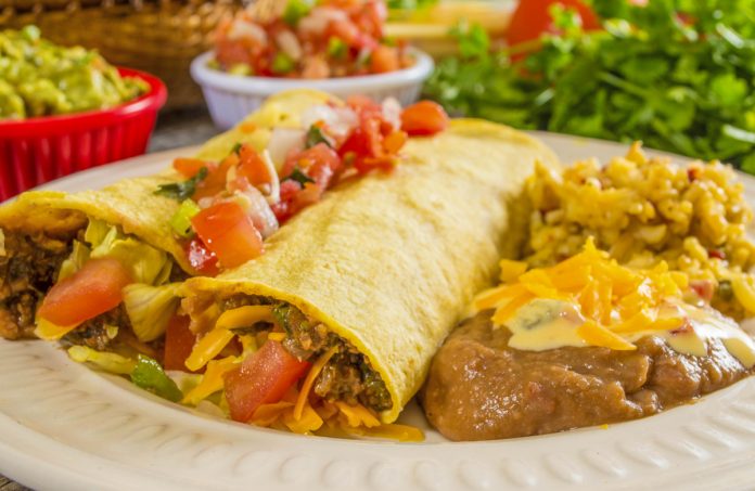 feature.web Beef Enchiladas with a side of refried beans and rice.