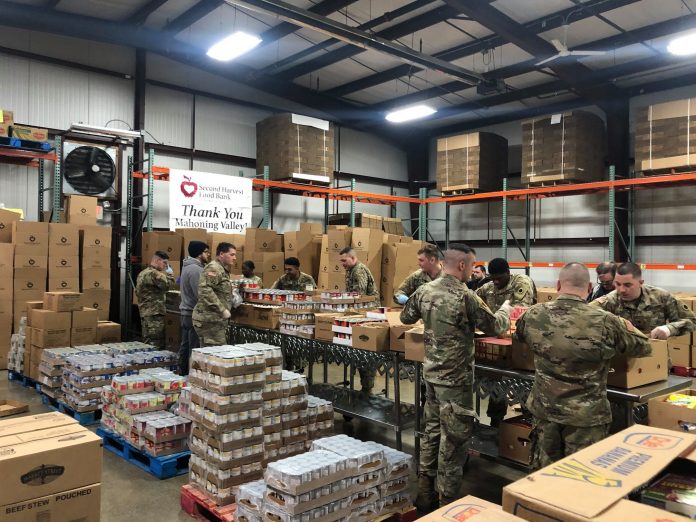 national guard members packing food
