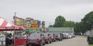 Cars line up next to concessionaires' stands at the Canfield Fairgrounds.