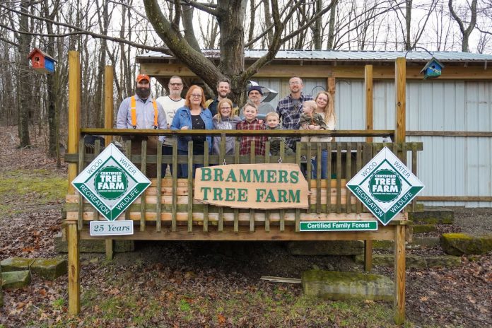 Brammer family tree farm family stands on deck at tree farm
