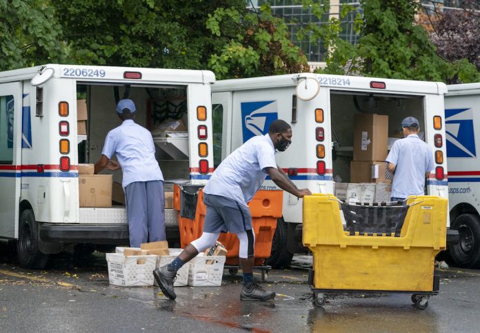 Election 2020 Voting Worries Letter carriers load mail trucks for delivery.