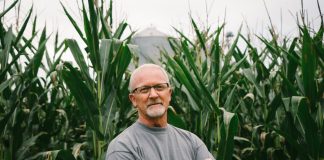 john linder stands in corn field