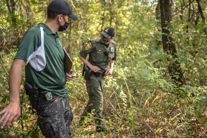 Ohio Wildlife Officers training at Woodbury Wildlife Area Two wildlife officers walk through the woods.