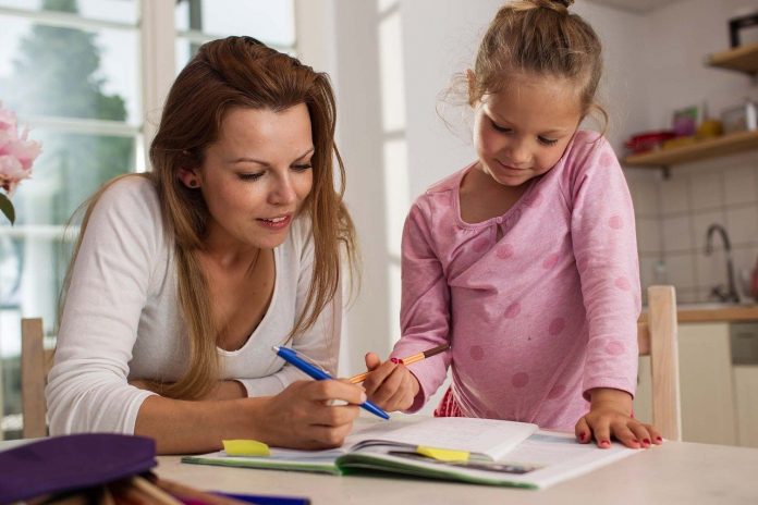 woman homeschooling child woman homeschooling child
