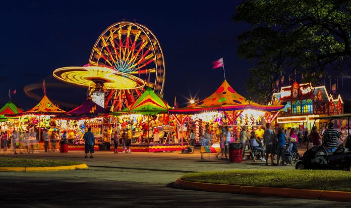fair metro amusement rides and games with lights at a fair at night.