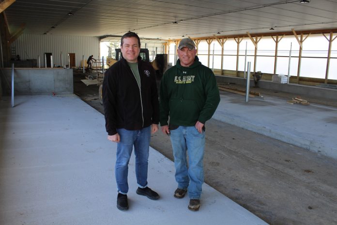 pleasant-lane-farms-1 men standing in new free stall barn
