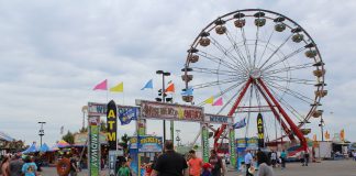 People and amusement rides at a fair.