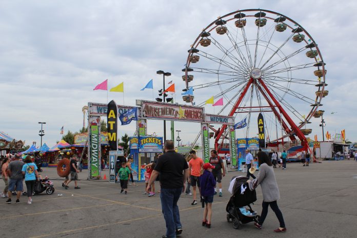 ride 3 People and amusement rides at a fair.