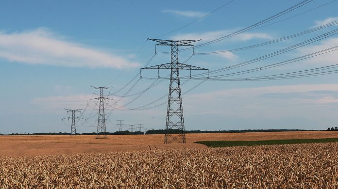 High Tension Power Lines Over Field High Tension Power Lines Over Field
