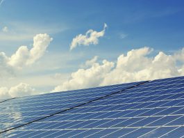 solar panels with cloud in the background