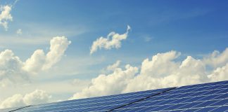 solar panels with cloud in the background