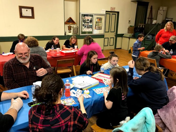 grange-4 people play board games together