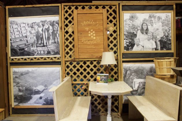 Pictures on display in a barn at a vineyard.