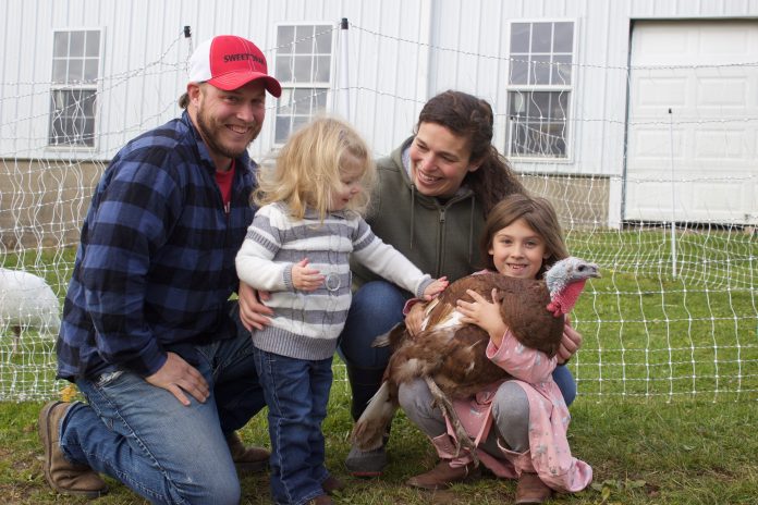 brockett_farms_3 A couple and their two daughters with a turkey.
