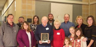 A family poses together after receiving an award.
