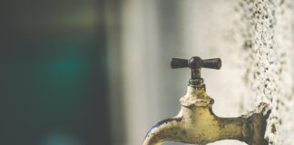 brass faucet with water droplets