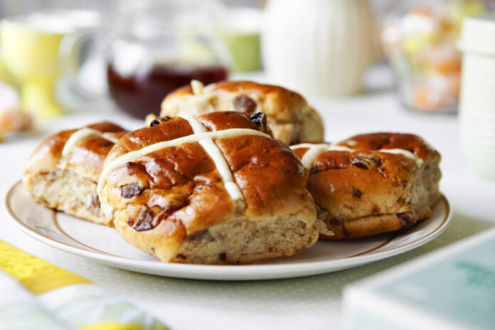 Hot cross buns on a plate.