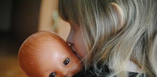 little girl with baby doll