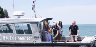 Researchers take water samples from a boat in Lake Erie