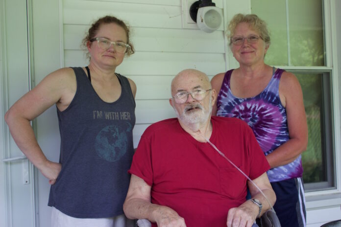 ingram_farms_1 Two women and a man on the porch of a farmhouse.
