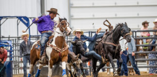 A student competes in a high school rodeo.