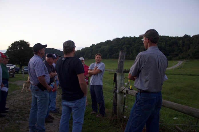 tusc_county_twilight_tour_4 A group of farmers stand near a fence at a beef cattle farm.