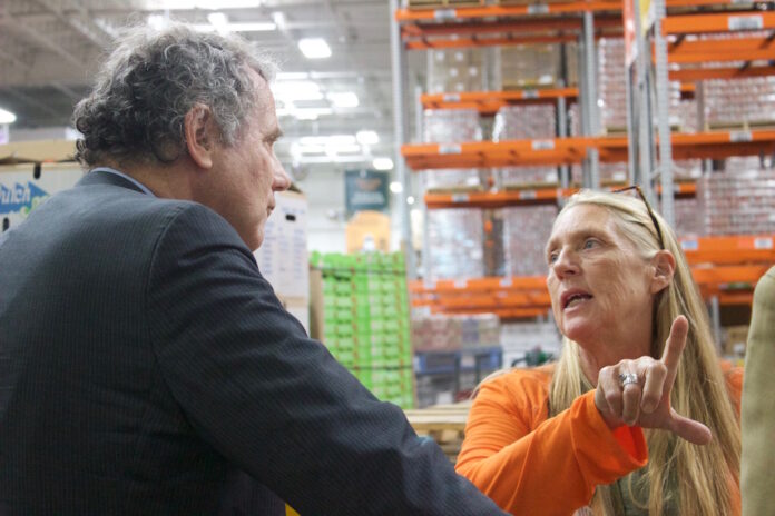 farm_bill_and_food_security_1 a man and a woman talk at a foodbank