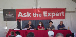 four people speak from a stage