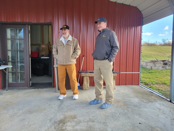 veteran-farmers two men standing together in front of a farm store