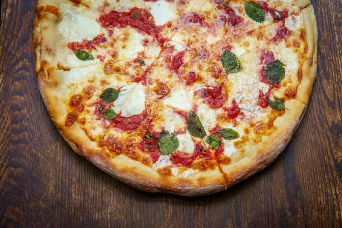 Margherita Pizza New York style Margherita pizza with fresh mozzarella and basil leaves