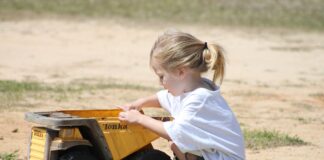 child playing in dirt