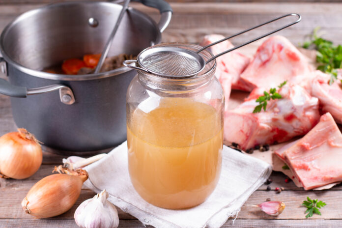 Passing the bone broth through a sieve. Concentrated Bone Broth in a Jar