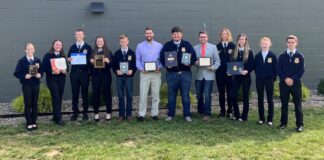 a group of FFA memebrs stand together for a group photo after winning an award