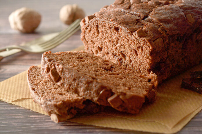 Piece of chocolate cake , fudge or pound cake. Wooden background.