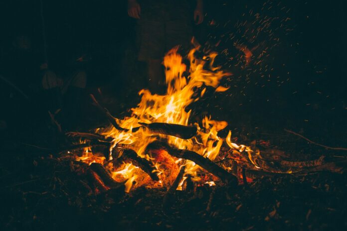 Photo by Luke Porter burning firewood at night